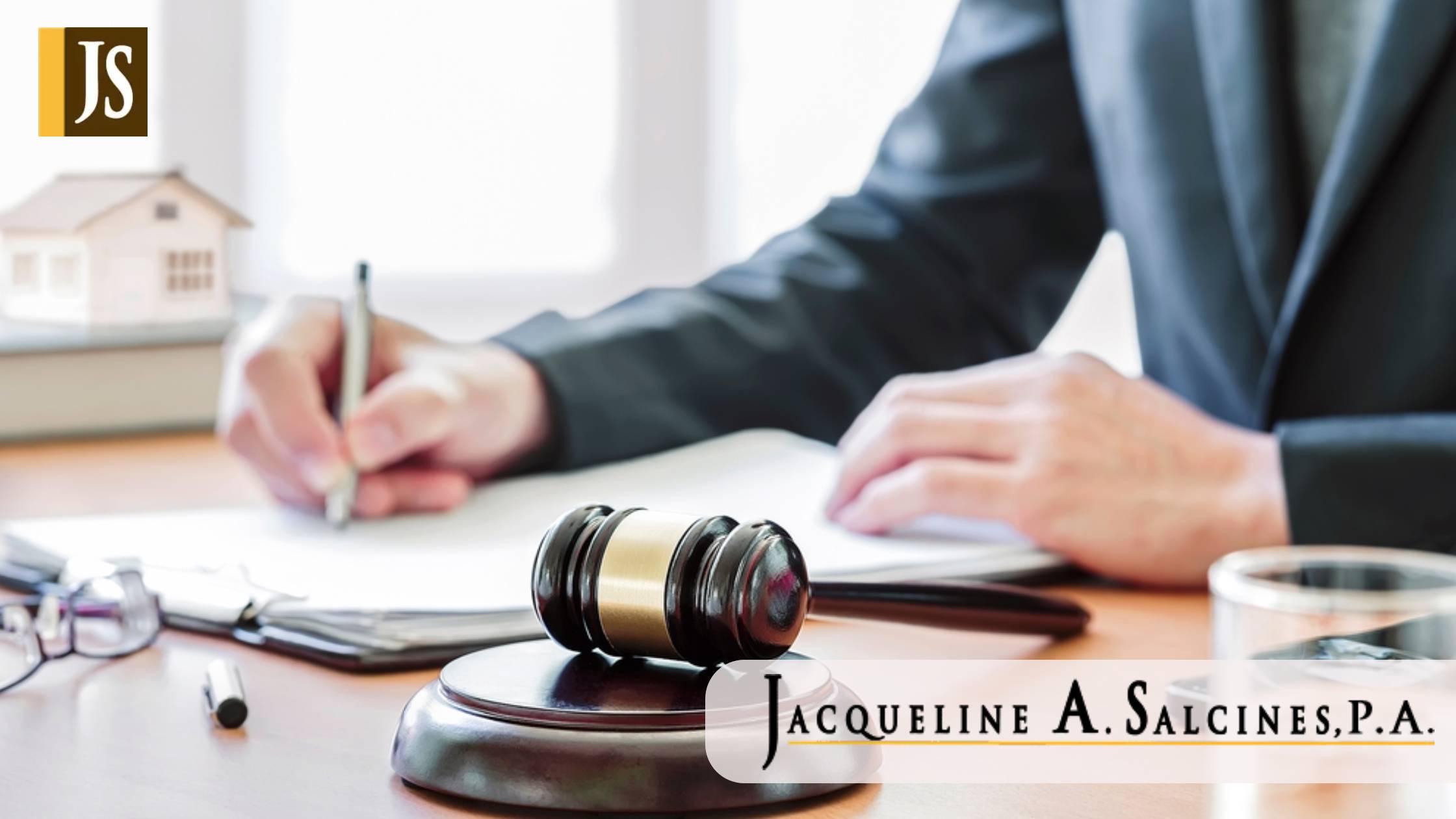 wooden gavel on the table with judge hand on background. Real Estate